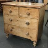 A late 19th/early 20th century pine chest of two long over two short drawers, turned wood handles,