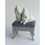 A Lladro figure of two Pekinese dogs