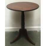 A 19th century mahogany tripod table, on ring-turned column and hipped sabre legs, 51x70cmH