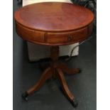 A small drum table with two drawers, on four swept legs, 50x59cmH