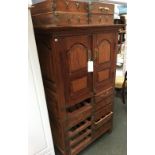 A hardwood cabinet of two panelled doors, above an arrangement of ten drawers, 102x60x168cmH