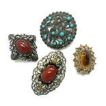 Two hardstone white metal brooches together with 2 others