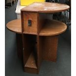 A mid century oak bedside table, possibly by Heals, comprising central drawer within an