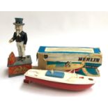 A Merlin electric speedboat tinplate toy, made by Sutcliffe model; together with an Uncle Sam