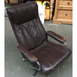 A 1970s leather and chrome reclining swivel armchair