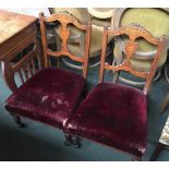 A pair of 19th century low occasional chairs, with marquetry inlaid rail and splat, stuffover