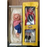 Two boxed Pelham puppets 'Red Riding Hood' and 'Pinky Pig'; together with four vintage racing signs