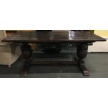 A good reproduction refectory table, five plank top with pleated ends, on substantial cup and