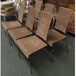 A Heals set of six wrought iron and wicker chairs; together with a matching circular table