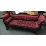 A Regency scroll end sofa, styled as a gondola, with carved top-rail on scrolling carved legs,