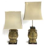A pair of substantial Chinese brass double dragon table lamps, of square baluster form, dragon heads