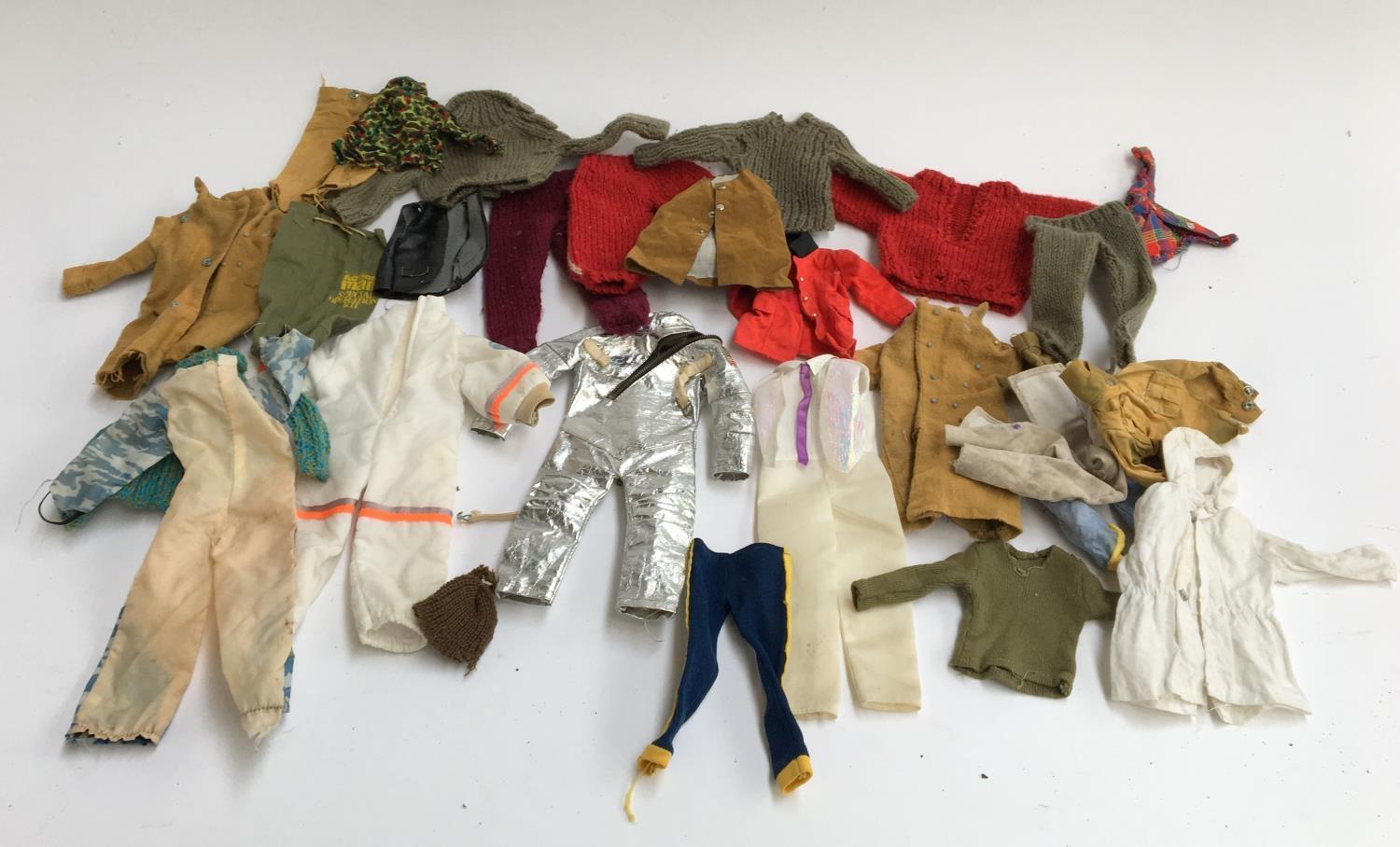 A mixed lot of dolls clothes, to include Action Man outfits and knitted jumpers