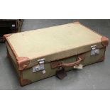 A vintage canvas suitcase with leather corner and trim, 68cmW