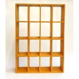 A wooden shelving display unit of 16 compartments, 49x70cmH