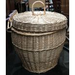 A wicker laundry basket with hinged lid