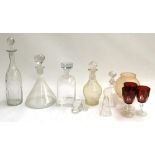 Three glass decanters with stoppers, the tallest 35cmH; together with three red Bohemia glasses