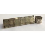 A set of six triangular silver plated napkin rings, each engraved with a figure; together with a