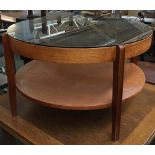 A mid century smoked glass circular coffee table, 76cmD, 46cmH