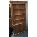 A pine bookcase of four shelves with cupboard below, 91x24x200cmH