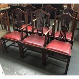 A set of six splatback dining chairs, with drop-in red vinyl seats (two carvers)