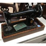 A Singer sewing machine serial no. EF785544, in mahogany carry case (damaged)