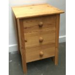 A contemporary pine bedside cabinet of three drawers, 43x40x61cmH