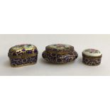 A set of three Limoges peint main pill and trinket boxes, with floral, blue and gilt design,