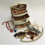 Cream jewellery box containing various bead necklaces and others