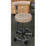 An industrial style office chair, vinyl upholstered sea and back rest on six casters