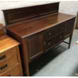 A late 19th/early 20th century mahogany sideboard, two central doors flanked by cupboards, on square