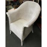 A white Lloyd Loom style wicker armchair