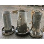 Three galvanised metal poultry feeders, two marked 'Eltex', approx. 60cmH