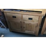 A contemporary light oak sideboard, two drawers over two cupboard doors, 97x46x78cmH