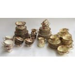 A part tea service, heightened in gilt; together with another with floral design, marked 'W Sons';