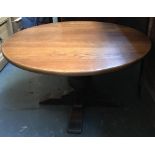 A 20th century oak circular coffee table, on cup and cover support, 95x53cmH