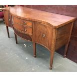 A serpentine fronted mahogany sideboard, flanked by two cupboards, 184x69x94cmH