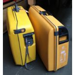 A pair of hard yellow pull-along suitcases