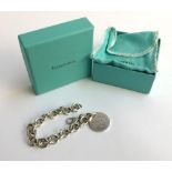 Tiffany & Co silver round link bracelet with Tiffany & Co charm, gross weight 37.2g. In original