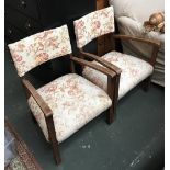 A pair of 20th century oak occasional chairs, with floral upholstered seats and backs