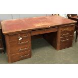 A very large 20th century kneehole desk, red leather top above an arrangement of drawers, approx.