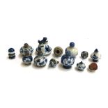 A small collection of 12 Oriental blue and white ceramic lids and stoppers