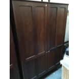A Mid century hardwood hanging wardrobe, fielded door detail, bears label A. Younger Ltd,