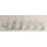 A set of six cut glass whiskey tumblers, engraved as golfing trophies; two tumblers engraved with