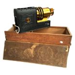 An early 20th century magic lantern projector, later electrical conversion, in wooden case