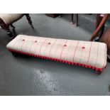 A newly upholstered 19th century low button footstool, red pom pom trim, 108x27x21cmH