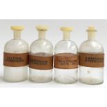 A set of four vintage lab bottles, with leather name bands