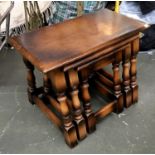 A nest of three stained pine tables, 60cmW