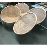 A set of four mid-century wicker garden chairs, circular form on steel legs