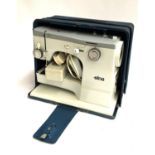 An Elna vintage electric sewing machine, in hard metal carry case