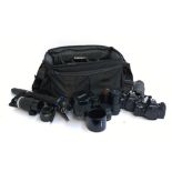 A Tenba equipment bag containing a quantity of photographic equipment, including two Praktica BX20